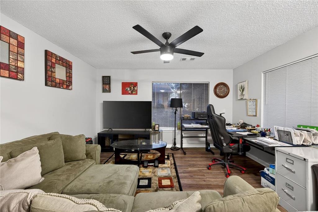 2739 Whitewater Court Austell, GA 30106 - Photo 10 of 18 a living room with furniture and a flat screen tv with wooden floor