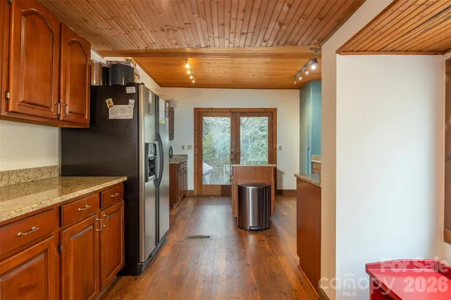 a hallway with a chair and wooden floor