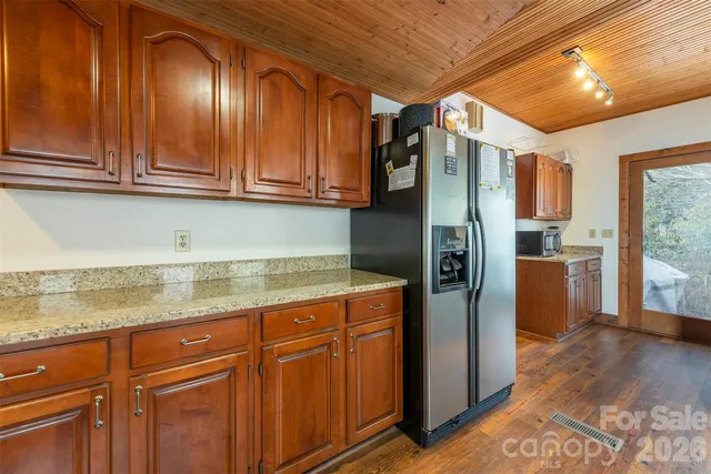 a kitchen with stainless steel appliances granite countertop a refrigerator and a sink