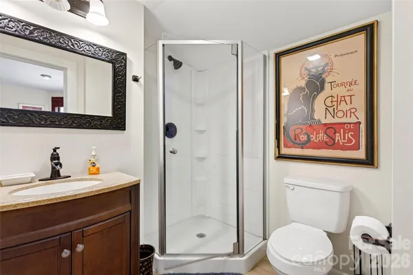 a bathroom with a toilet a sink and glass door