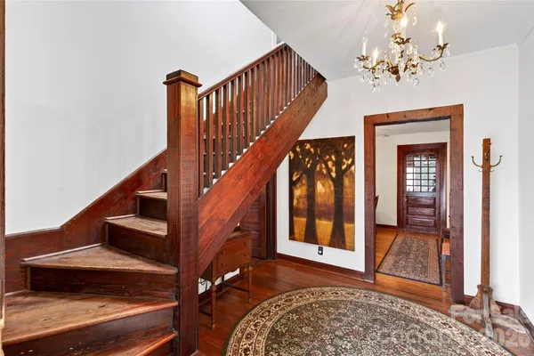a view of entryway and hall with wooden floor
