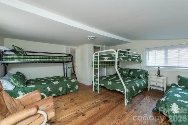 a bedroom with furniture and a wooden floor