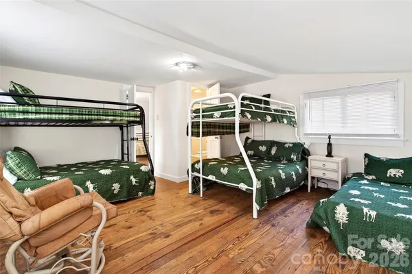 a bedroom with furniture and a wooden floor