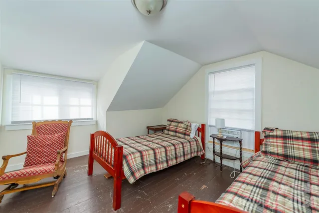 a bedroom with furniture and a window