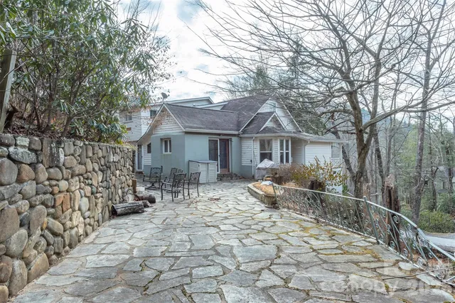 a view of house with backyard outdoor seating and trees
