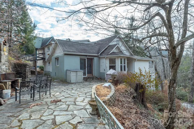 a front view of house with yard outdoor seating and barbeque oven