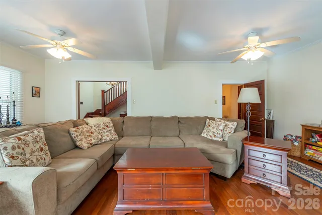 a living room with furniture and a lamp