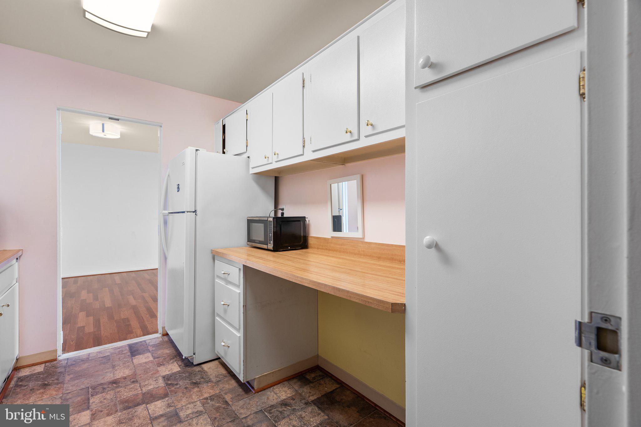 9701 Fields Road, Unit 1800 Gaithersburg, MD 20878 - Photo 6 of 16 a utility room with cabinets washer and dryer