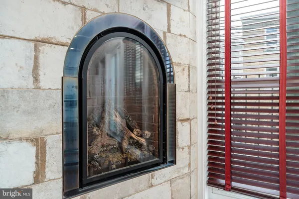 a close view of a fireplace with a hallway