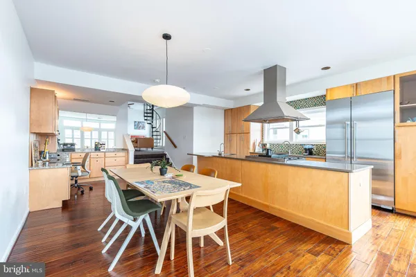 a dining room filled with furniture and wooden floor