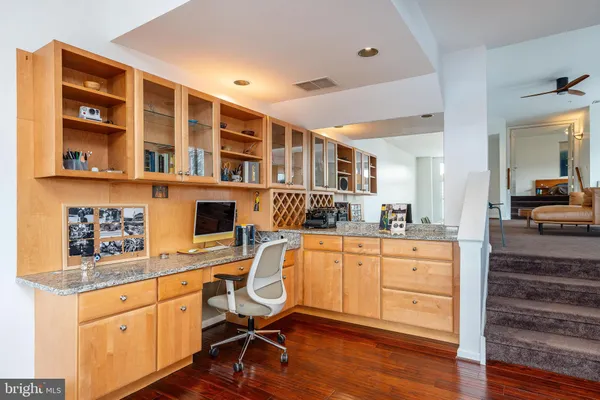 a view of a workspace with furniture and wooden floor