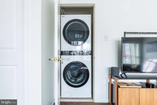 a view of a living room with washer and dryer
