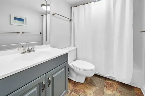 a bathroom with a sink toilet and shower