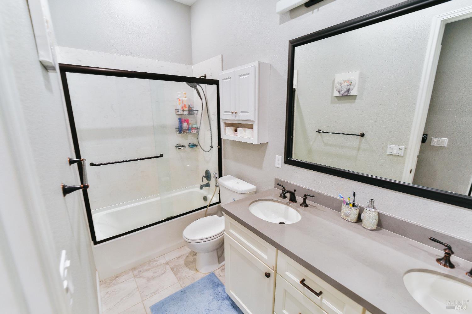 1331 Ridgecrest Court Santa Rosa, CA 95403 - Photo 7 of 19 a bathroom with a granite countertop sink mirror vanity and toilet