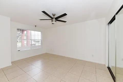 a view of a livingroom with a ceiling fan and window