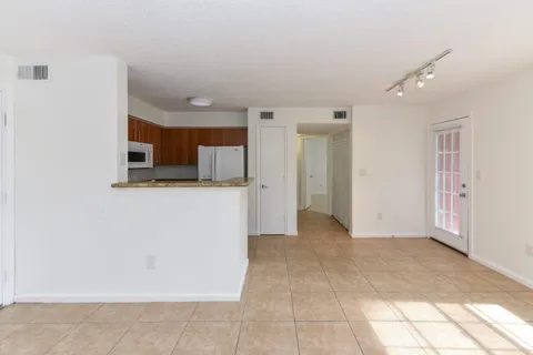 a view of a refrigerator in kitchen and window