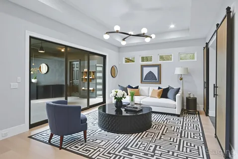 a large kitchen with stainless steel appliances kitchen island granite countertop a refrigerator and a sink