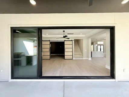 a view of an empty room with a window and fireplace