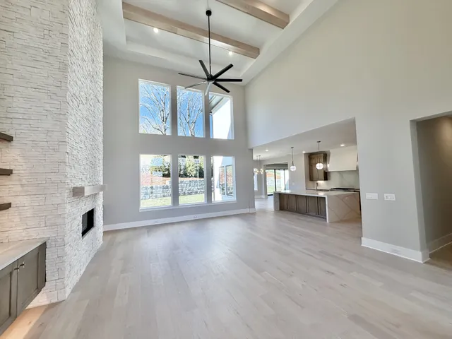 a large living room with stainless steel appliances wooden floors and view living room
