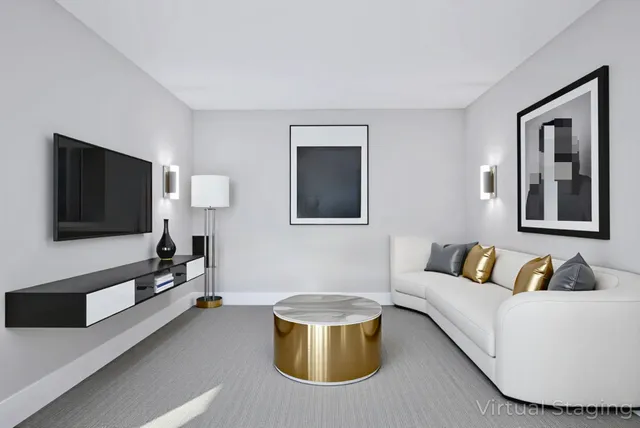 an empty room with wooden floor and a ceiling fan