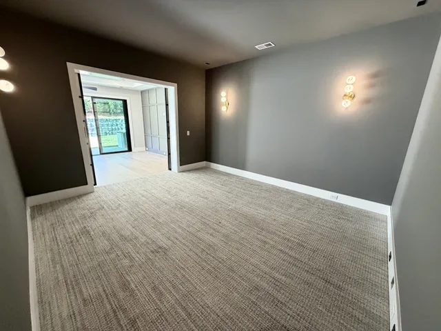 an empty room with wooden floor and window