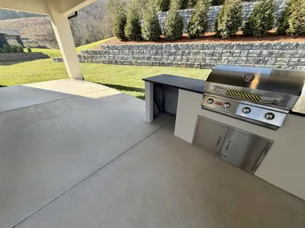 a view of empty room with wooden floor and electronic appliances