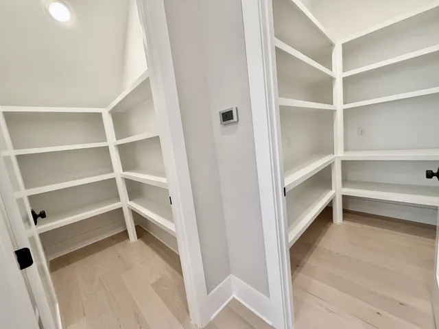 an empty room with windows and ceiling fan view