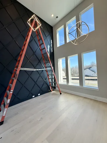 a large kitchen with stainless steel appliances kitchen island granite countertop a large counter top and wooden floors