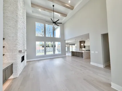 a large kitchen with granite countertop a stove a sink a window and dining table