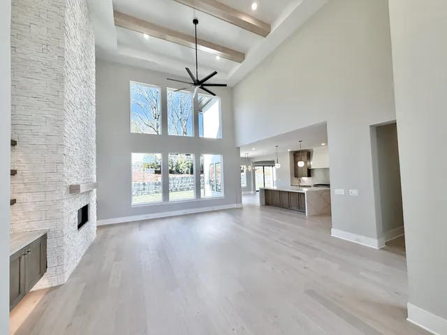 a large kitchen with granite countertop a stove a sink a window and dining table
