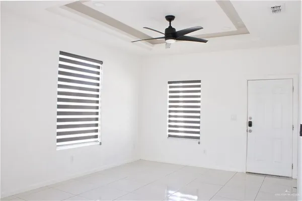a view of a livingroom with a ceiling fan and a window