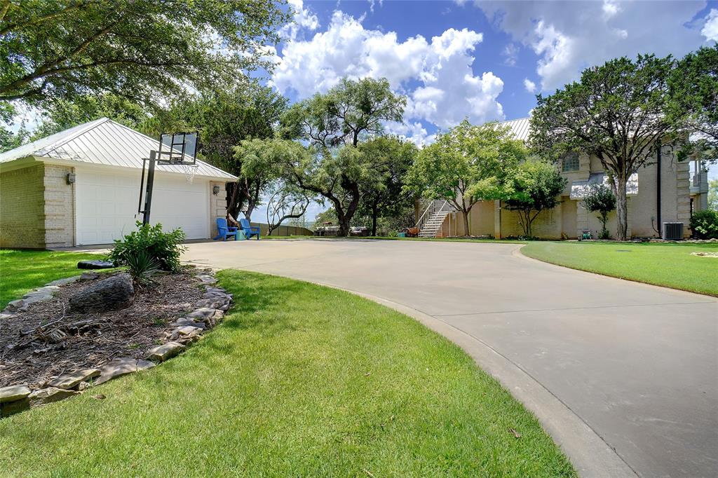 1003 Mesquite Ridge Graford, TX 76449 - Photo 13 of 40 a backyard of a house with plants and large tree