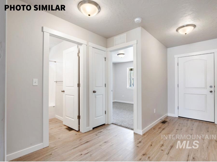 925 Twilight Weiser, ID 83672 - Photo 2 of 31 Entryway featuring wood-finish flooring, light gray walls, and white trim