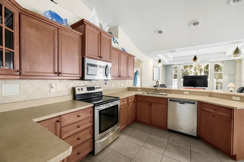 24 Regency Drive Palm Coast, FL 32164 - Photo 12 of 36 a kitchen with stainless steel appliances granite countertop a sink and cabinets