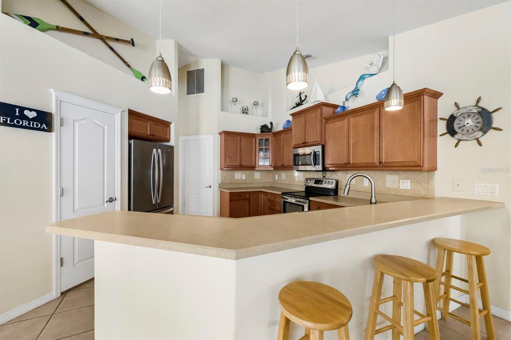 24 Regency Drive Palm Coast, FL 32164 - Photo 13 of 36 a kitchen with stainless steel appliances granite countertop a sink and a refrigerator