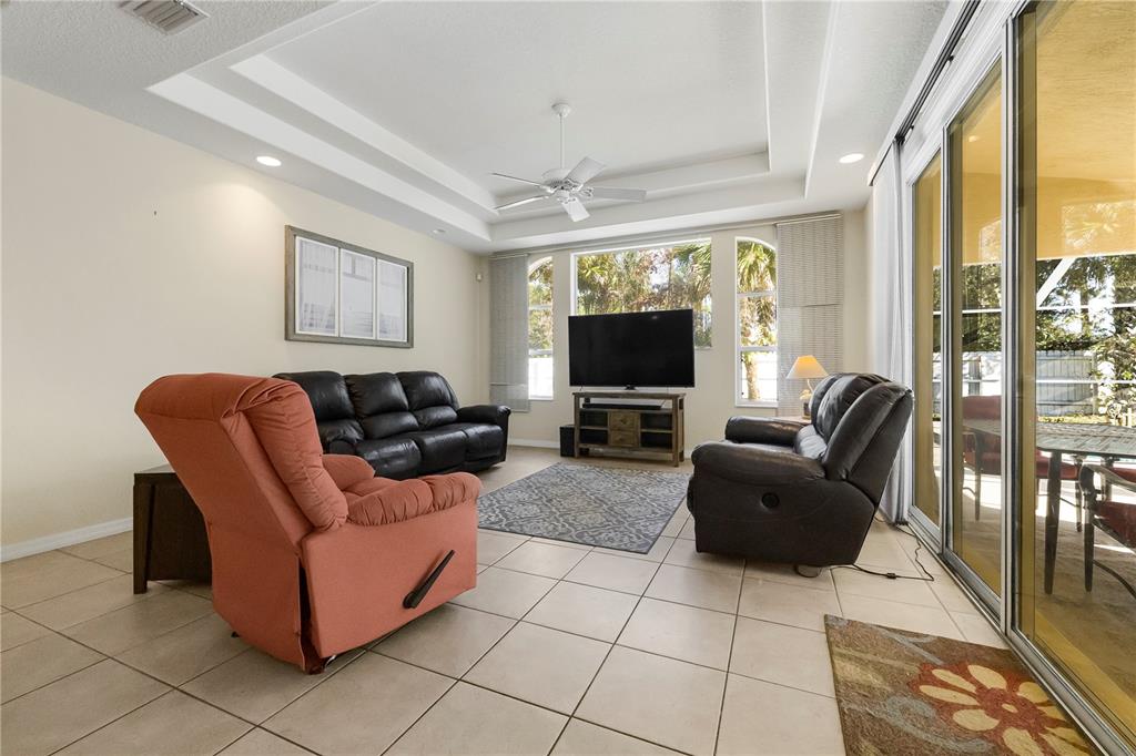 24 Regency Drive Palm Coast, FL 32164 - Photo 15 of 36 a living room with furniture and a flat screen tv