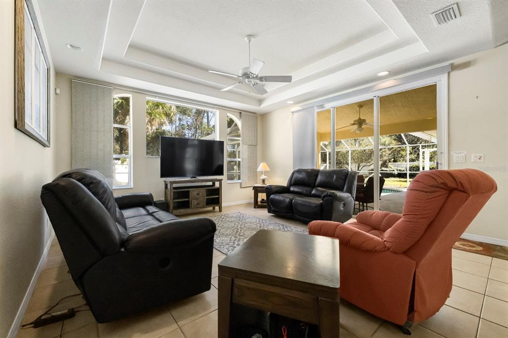 24 Regency Drive Palm Coast, FL 32164 - Photo 16 of 36 a living room with furniture and a flat screen tv