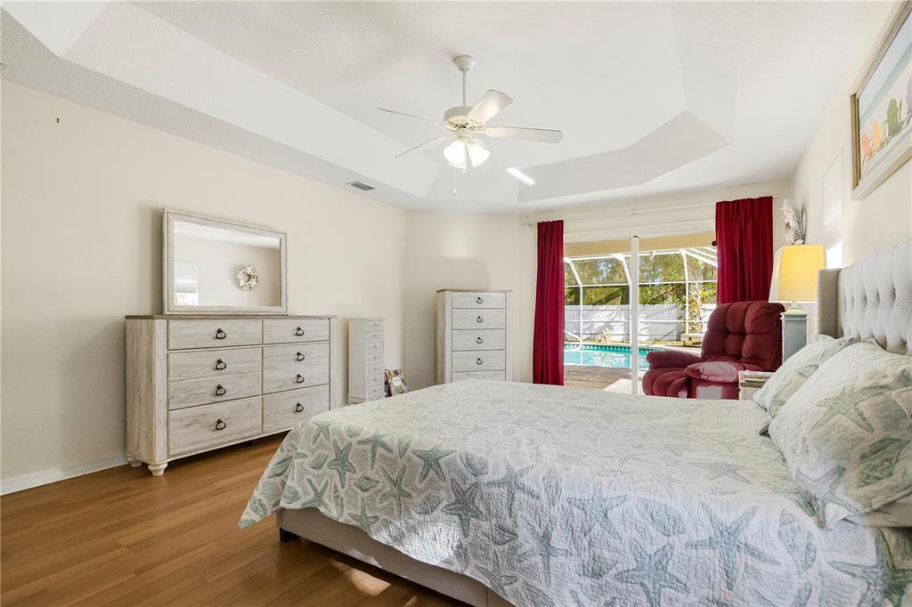 24 Regency Drive Palm Coast, FL 32164 - Photo 19 of 36 a bedroom with a bed and a dresser