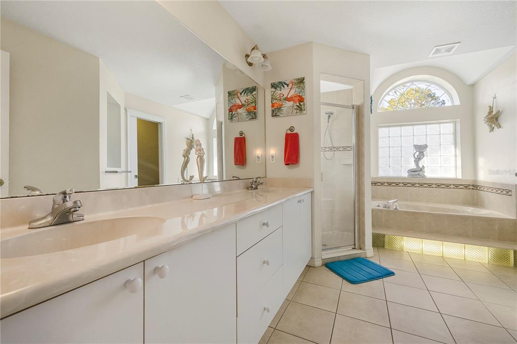 24 Regency Drive Palm Coast, FL 32164 - Photo 20 of 36 a bathroom with a granite countertop sink and a mirror