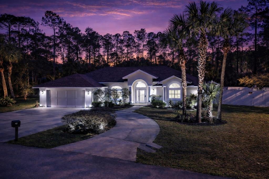 24 Regency Drive Palm Coast, FL 32164 - Photo 2 of 36 a front view of a house with garden