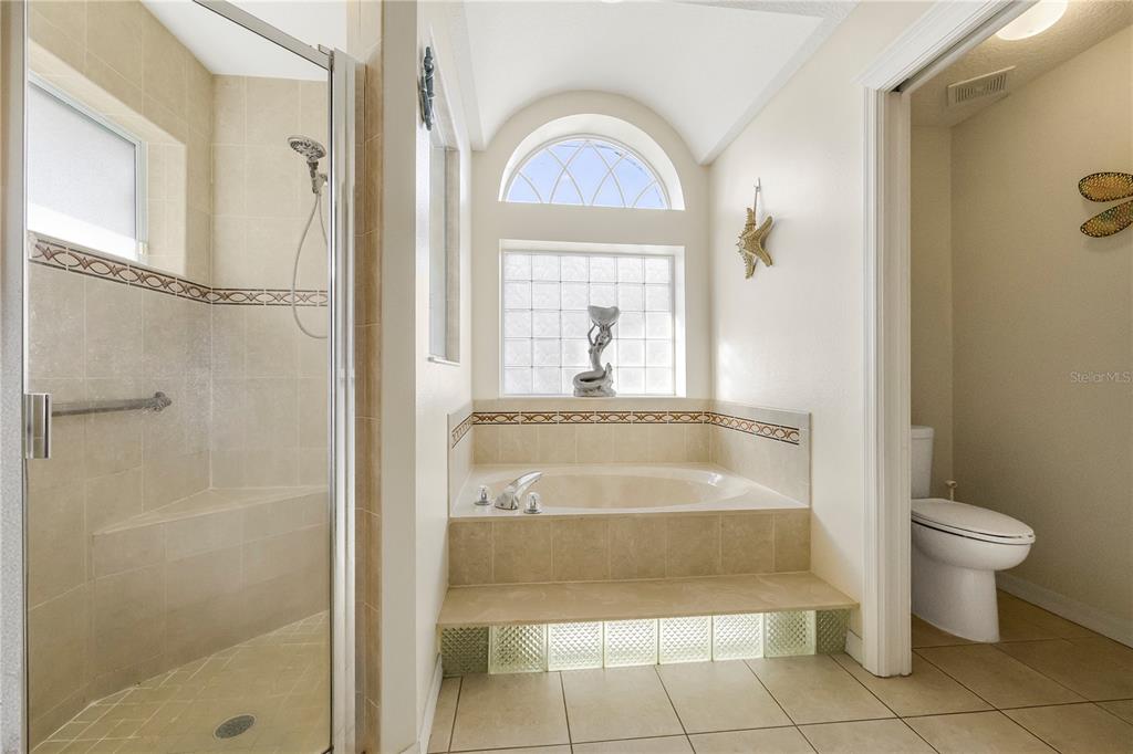 24 Regency Drive Palm Coast, FL 32164 - Photo 21 of 36 a bathroom with a tub shower and a sink