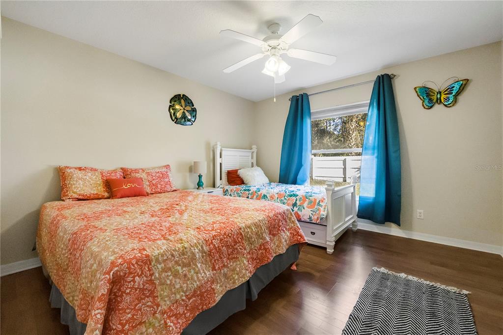 24 Regency Drive Palm Coast, FL 32164 - Photo 22 of 36 a bedroom with a bed and a table in it