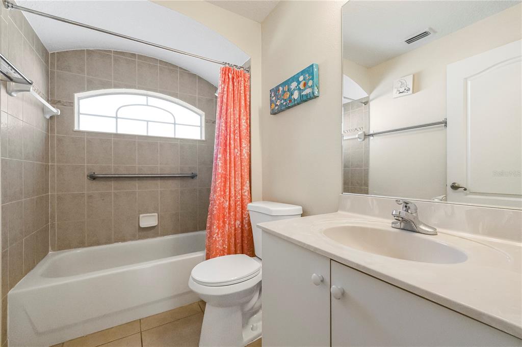 24 Regency Drive Palm Coast, FL 32164 - Photo 24 of 36 a bathroom with a sink a toilet and a bathtub