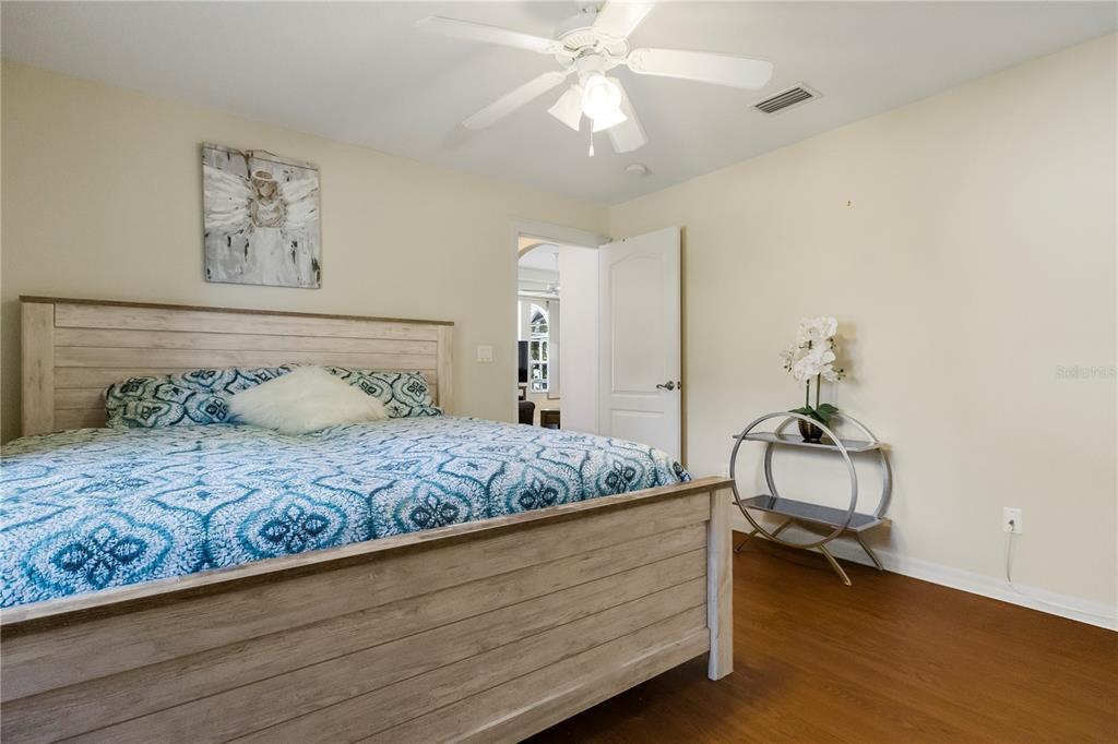 24 Regency Drive Palm Coast, FL 32164 - Photo 26 of 36 a bedroom with a bed and a chandelier
