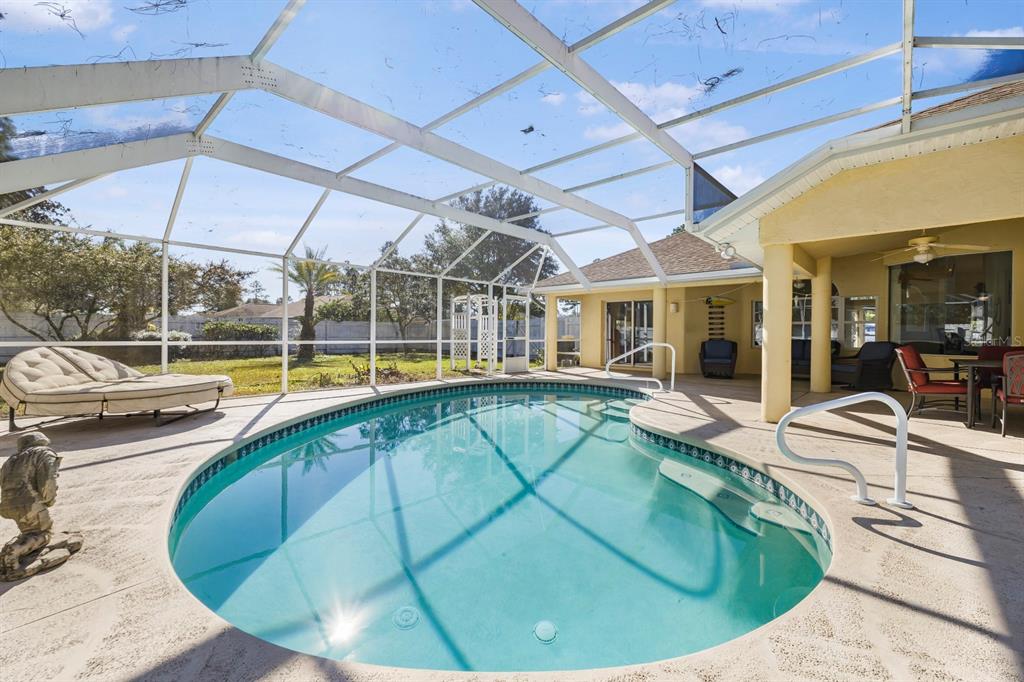 24 Regency Drive Palm Coast, FL 32164 - Photo 6 of 36 a view of a swimming pool with a patio