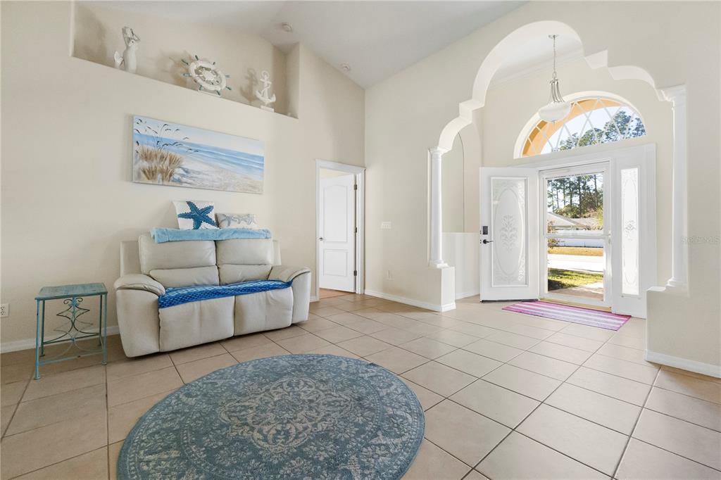 24 Regency Drive Palm Coast, FL 32164 - Photo 9 of 36 a view of living room with furniture and wooden floor