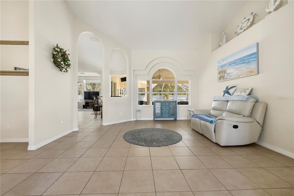 24 Regency Drive Palm Coast, FL 32164 - Photo 10 of 36 a living room with furniture and a fireplace