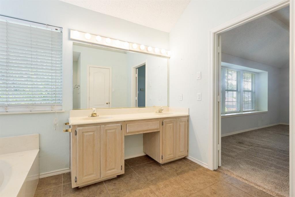 4709 Portrait Lane Plano, TX 75024 - Photo 18 of 22 Dual-sink vanity with ample counter space and direct access to the primary suite.