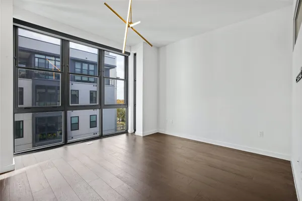 a kitchen with stainless steel appliances a refrigerator and wooden floor