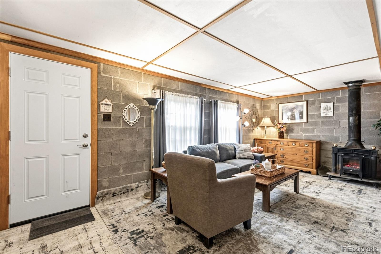 25845 Wilkerson Road Conifer, CO 80433 - Photo 5 of 16 a living room with furniture a flat screen tv and a window